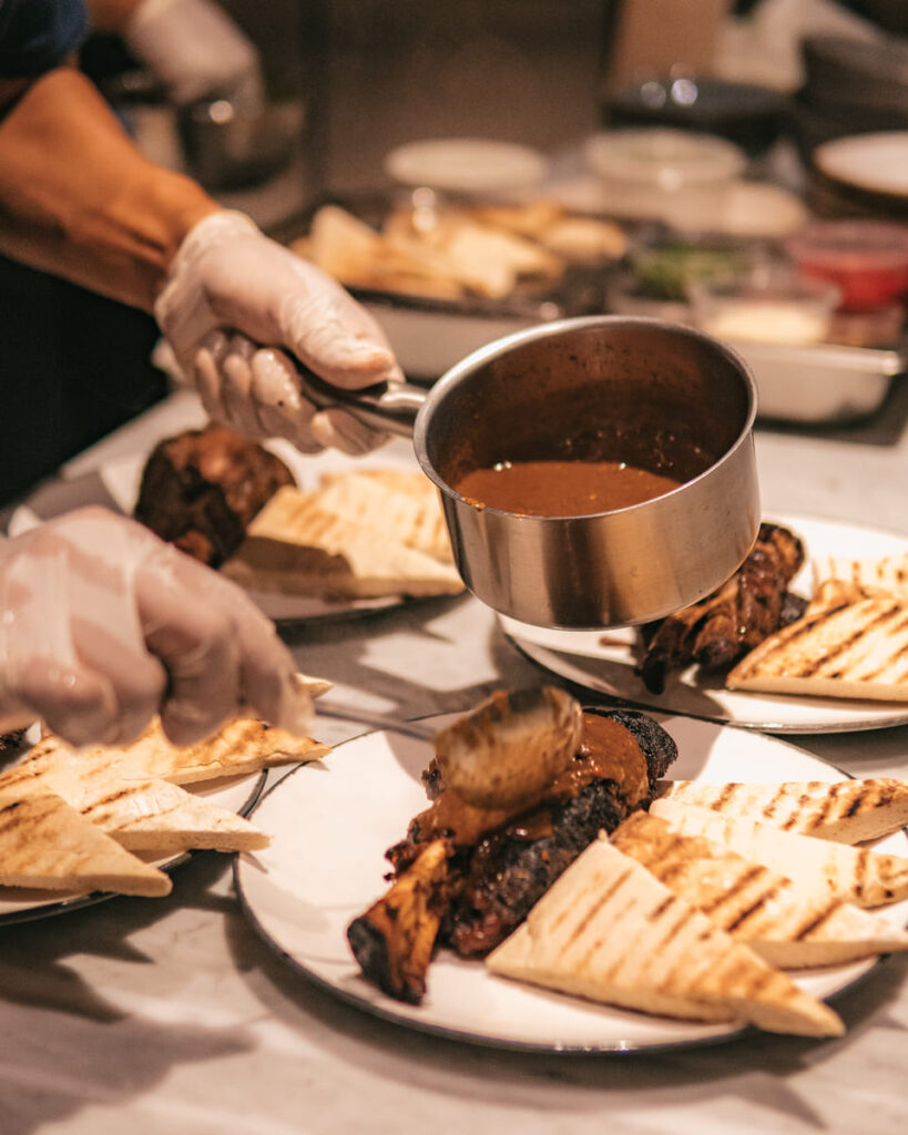 Chef kilo is arranging food on a plate