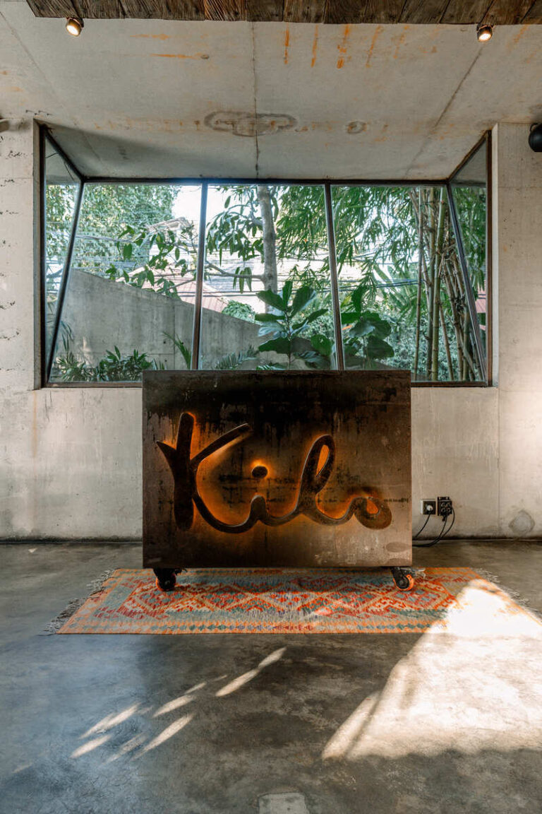 A large sign displaying the word "kilo" prominently positioned in the center of a spacious room.