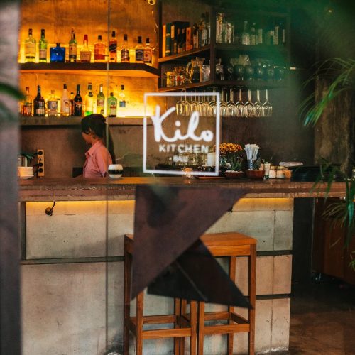 Kilo Kitchen Bali bar area with neon signage, Seminyak restaurant