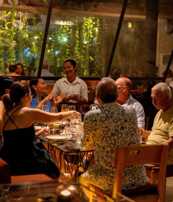 Guests enjoying dinner together in Kilo Kitchen Bali's warm and inviting dining space.