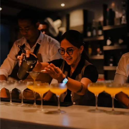Kilo Kitchen Bali bartender preparing Screwzudriver cocktails behind the bar