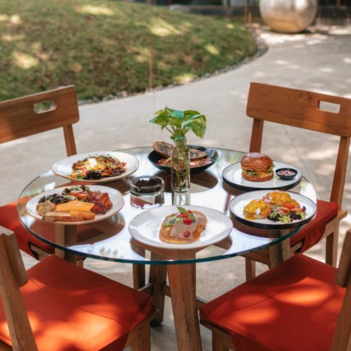 Breakfast dishes served on a table in Kilo Kitchen’s outdoor dining area