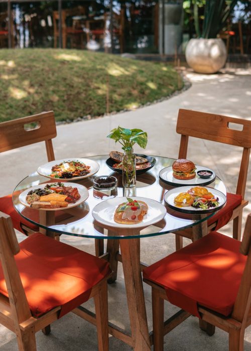 Breakfast dishes served on a table in Kilo Kitchen’s outdoor dining area