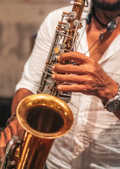 Musician playing a saxophone during a live event